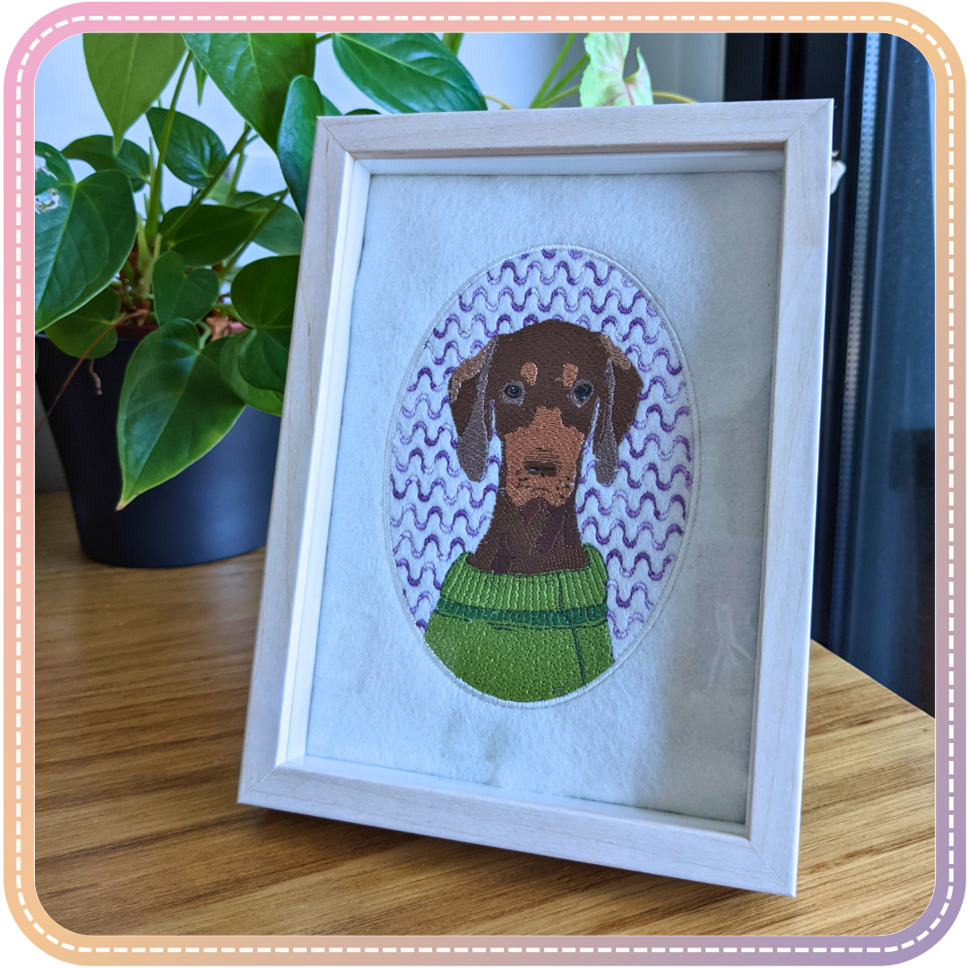 embroidery of a dog in a small white frame