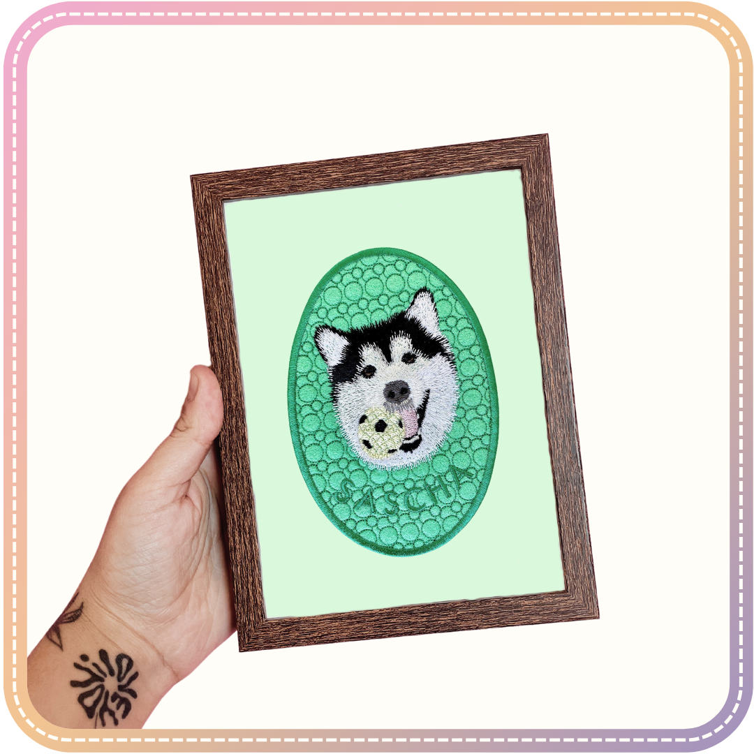 embroidery of a dog called Sascha in a small dark wood coloured frame