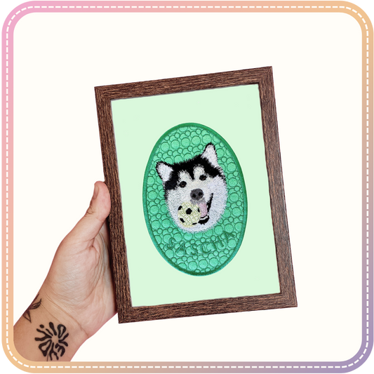 embroidery of a dog called Sascha in a small dark wood coloured frame