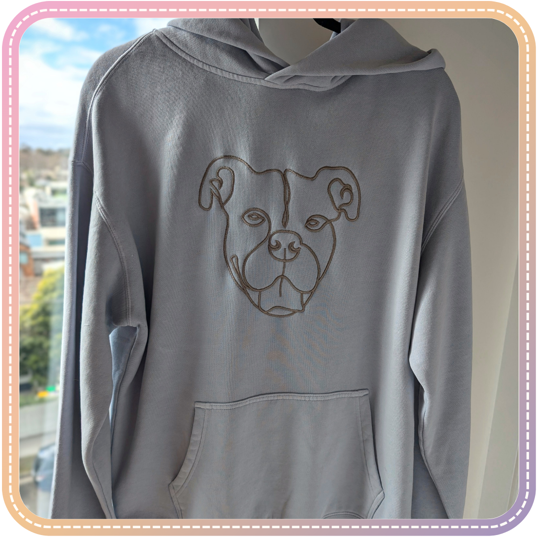 blue hoodie with large outline style embroidery of a dog