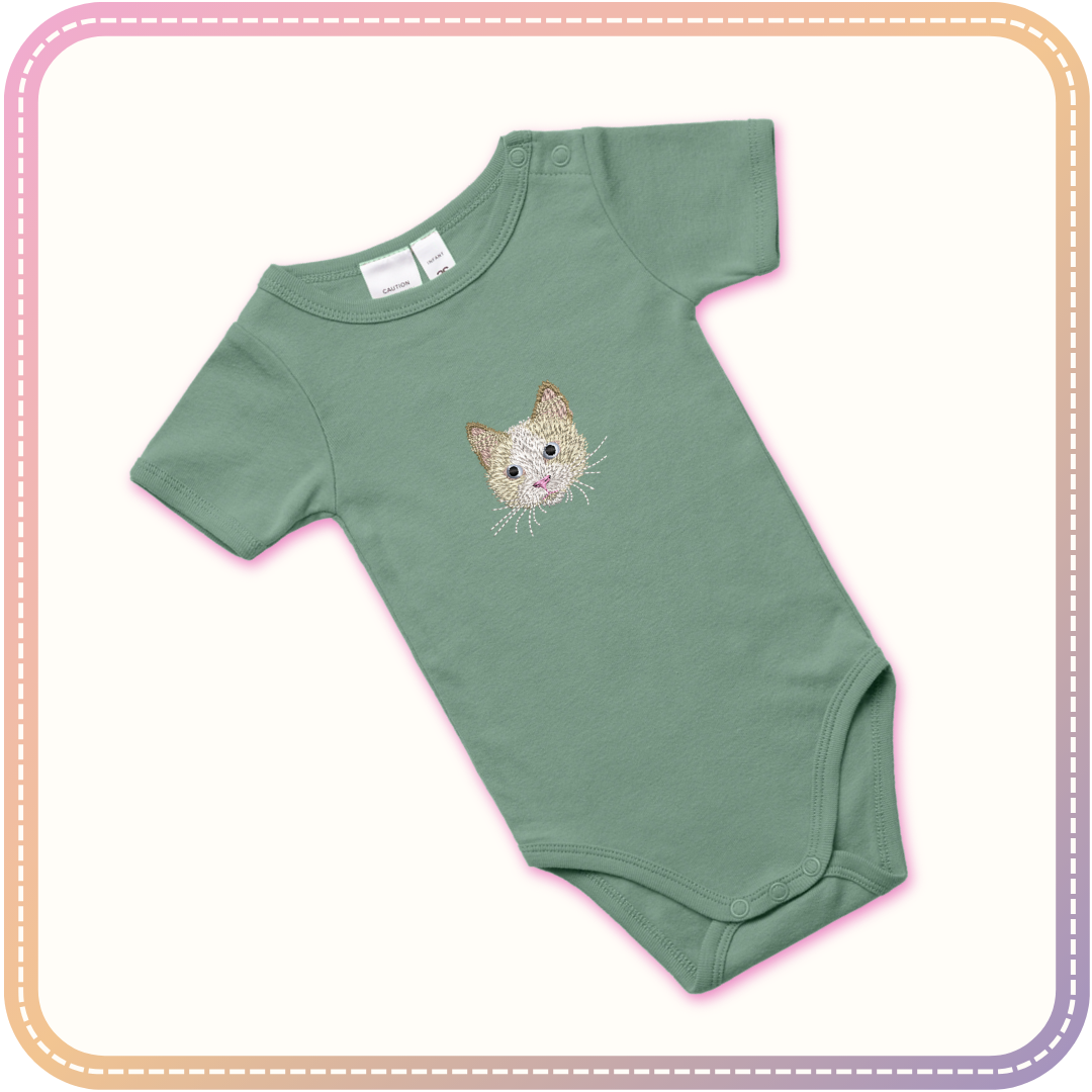 mockup of a sage green baby onesie with a cat embroidered in the centre