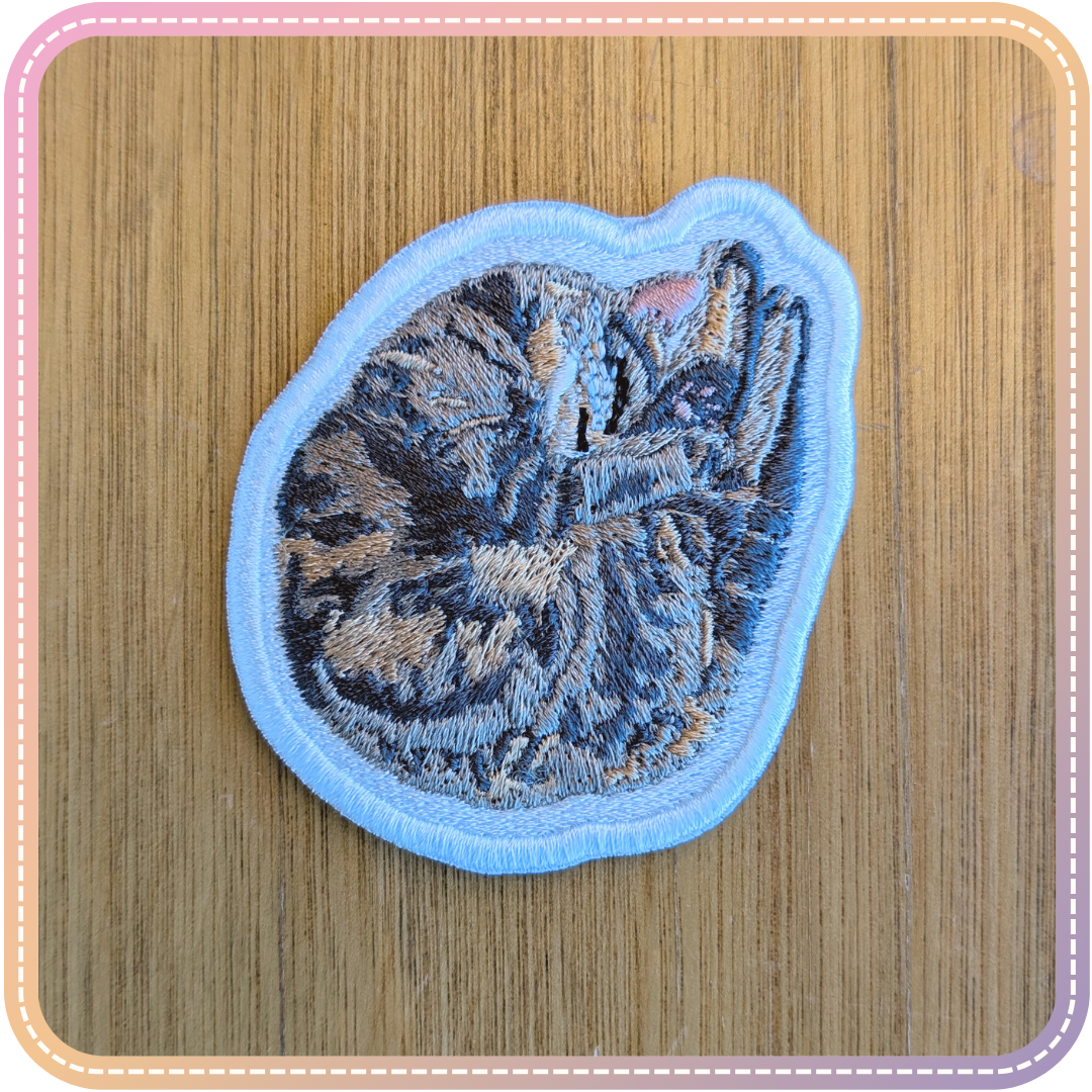 embroidery patch of a tabby cat (morgan) sleeping