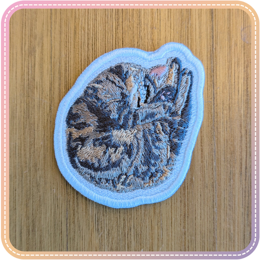 embroidery patch of a tabby cat (morgan) sleeping